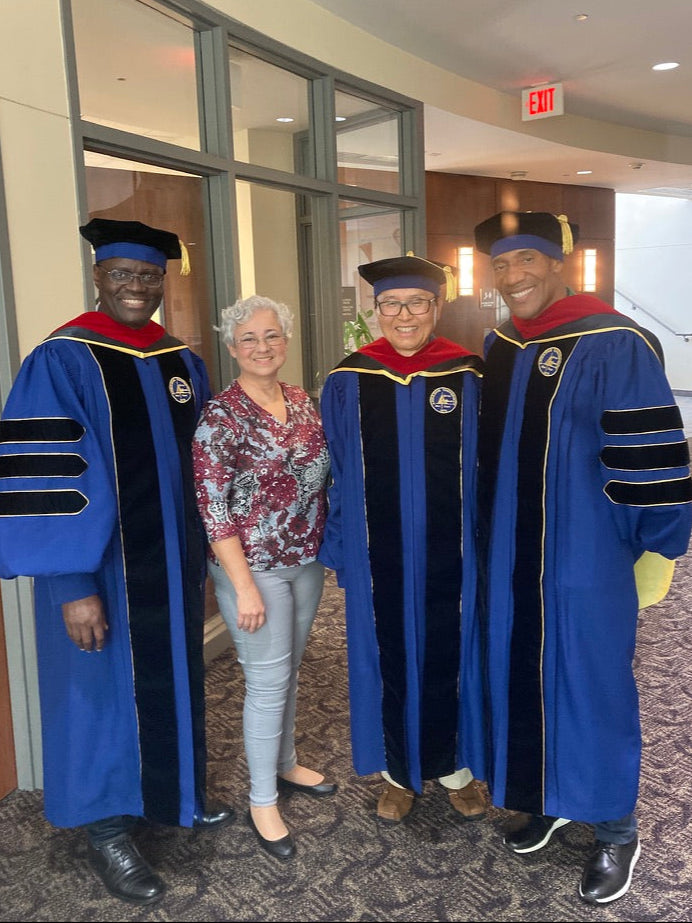 "Andrews University doctoral gown in Admiral blue with gold trim.".