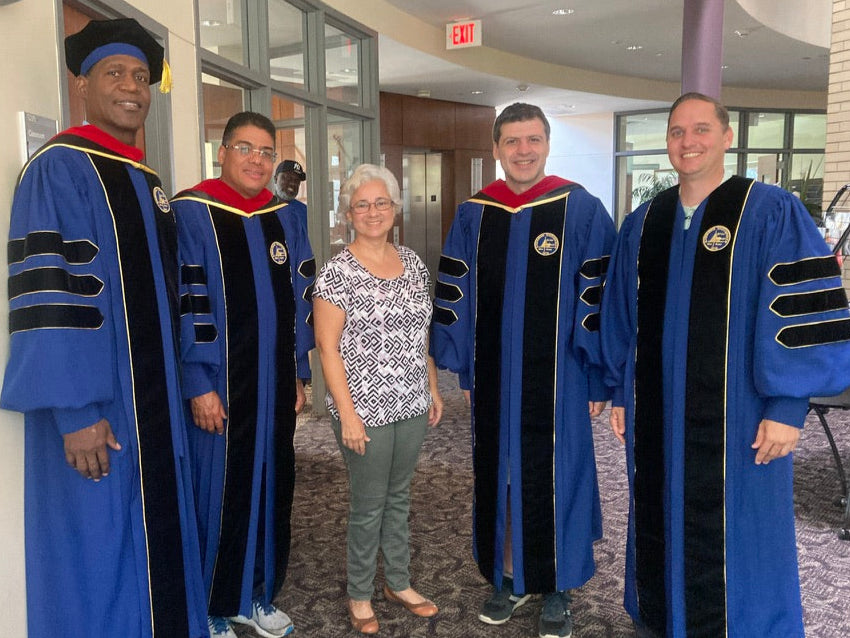 "Andrews University doctoral gown in Admiral blue with gold trim.".
